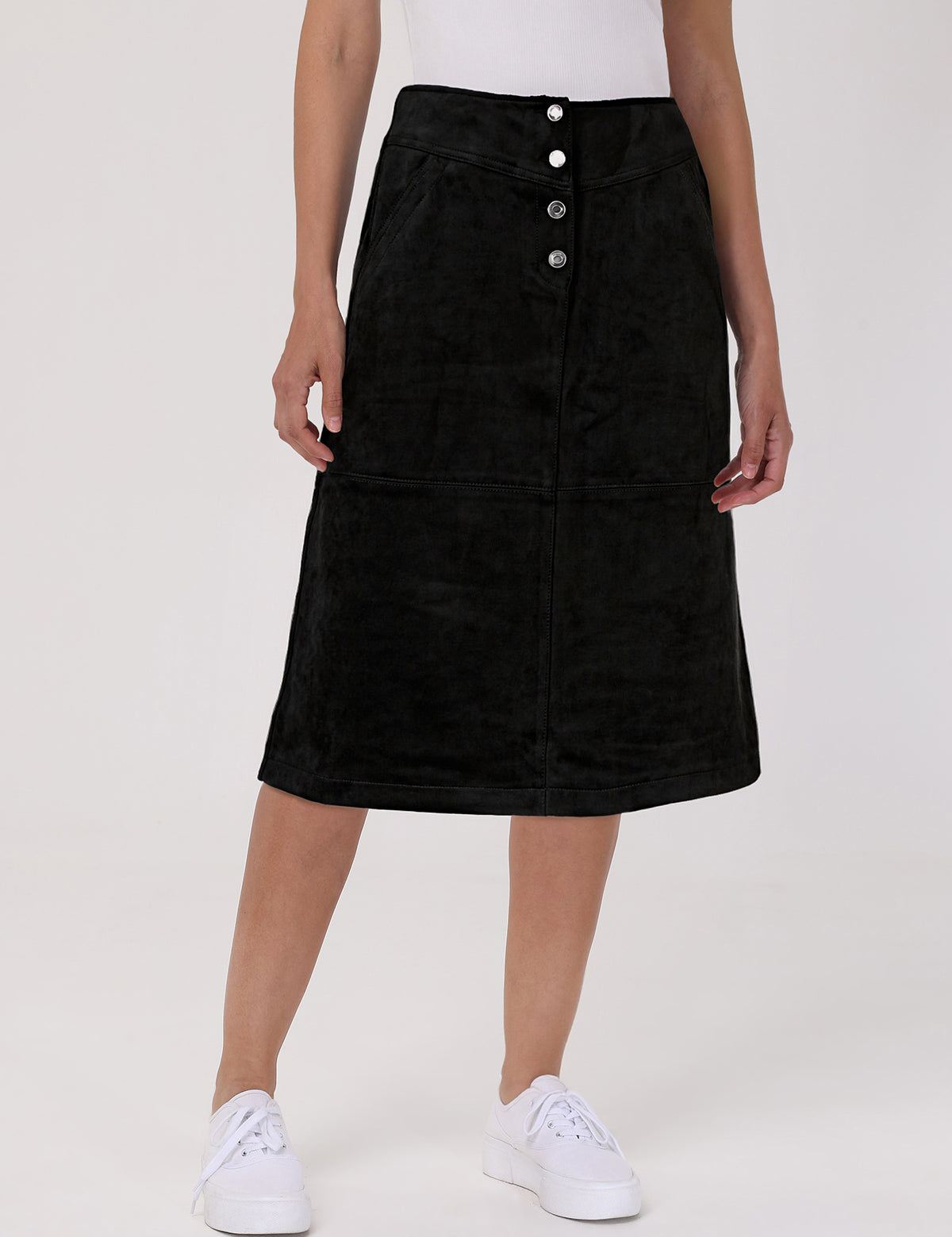 Black skirt with button details worn by a person on a white background
