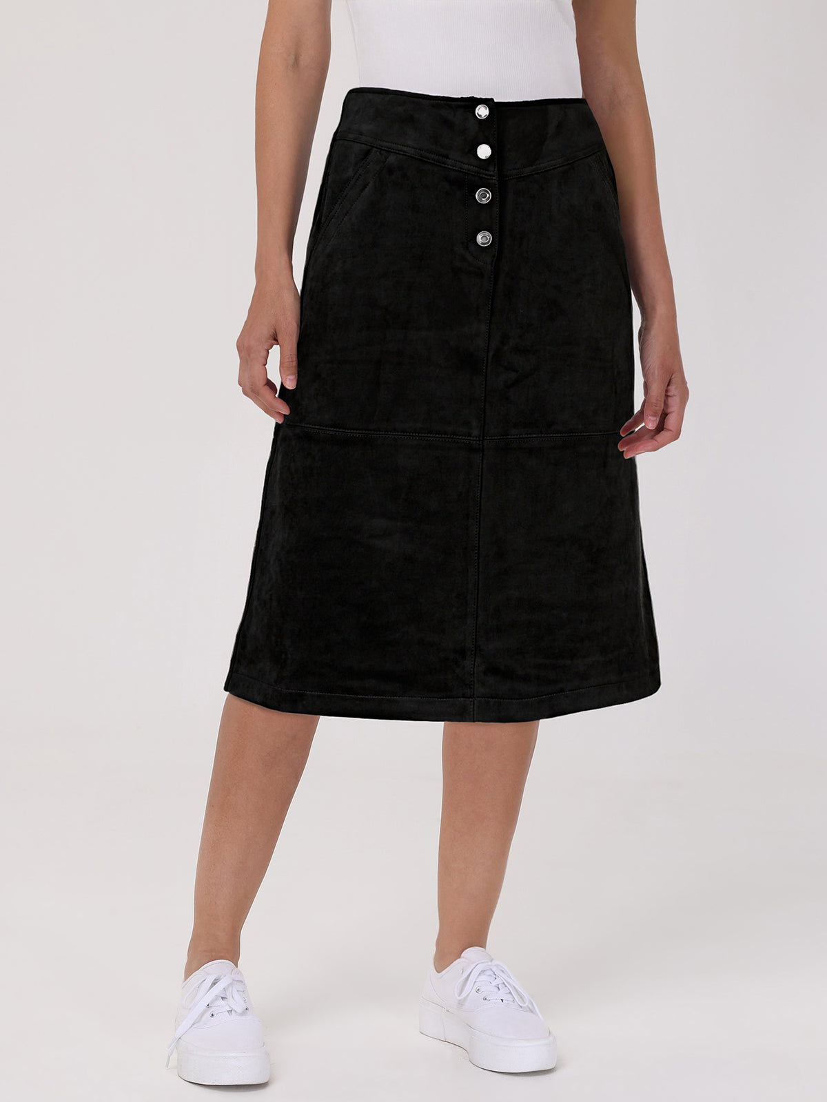 Black skirt with button details worn by a person on a white background