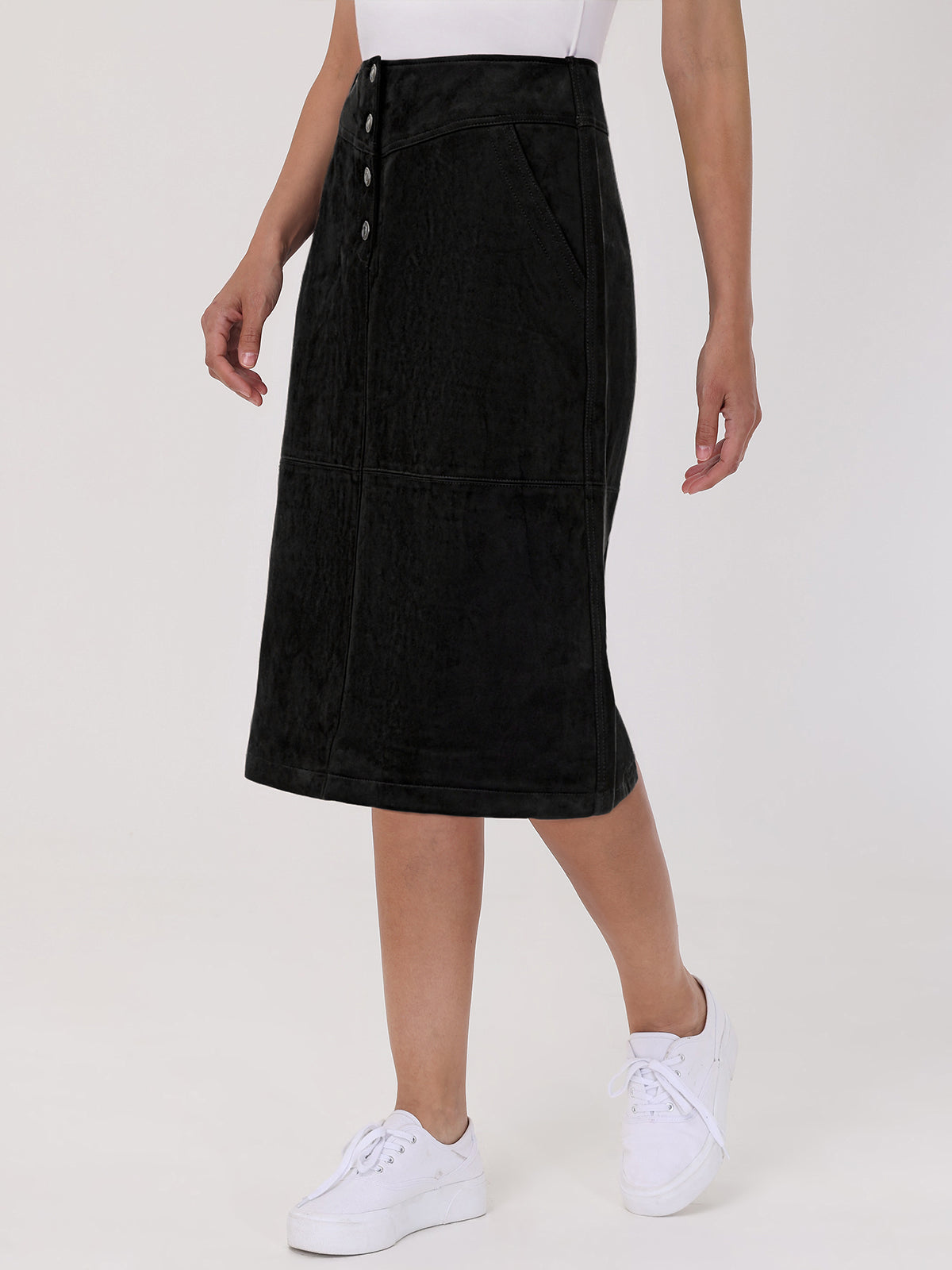 Person wearing a black skirt with buttons on a white background
