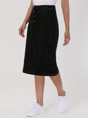 Person wearing a black skirt with buttons on a white background