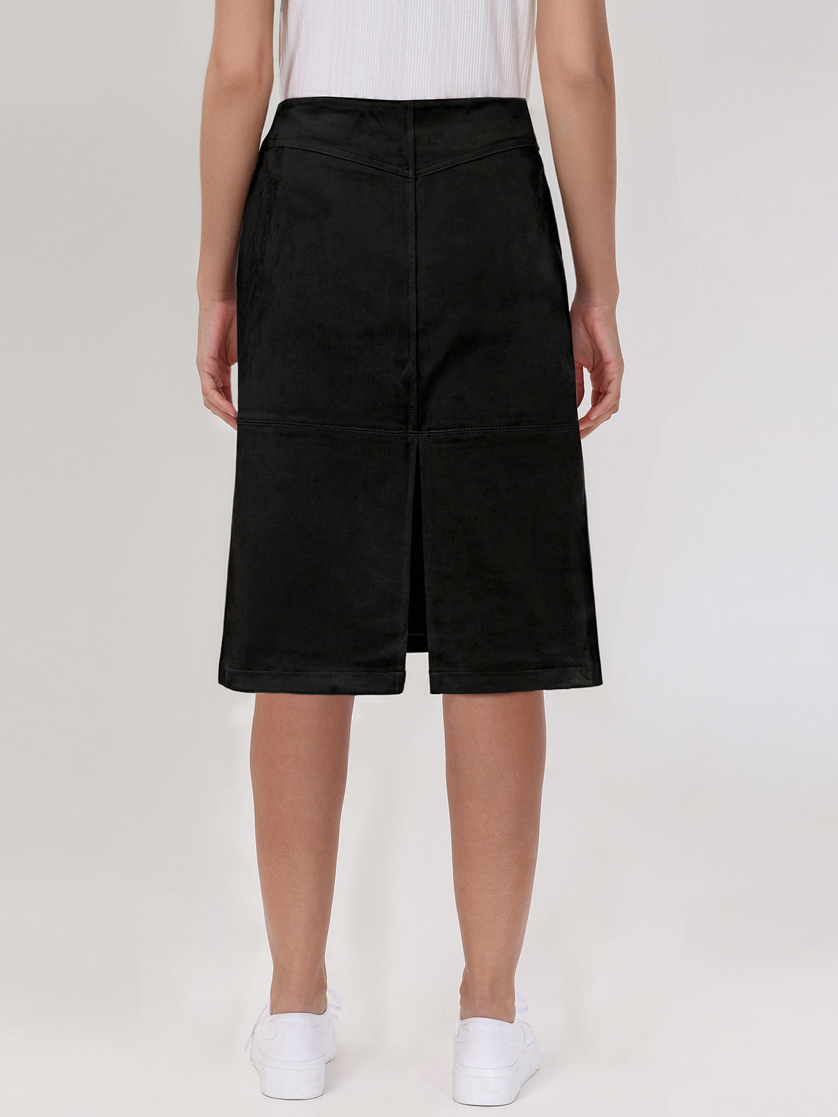 Black skirt worn by a person on a white background