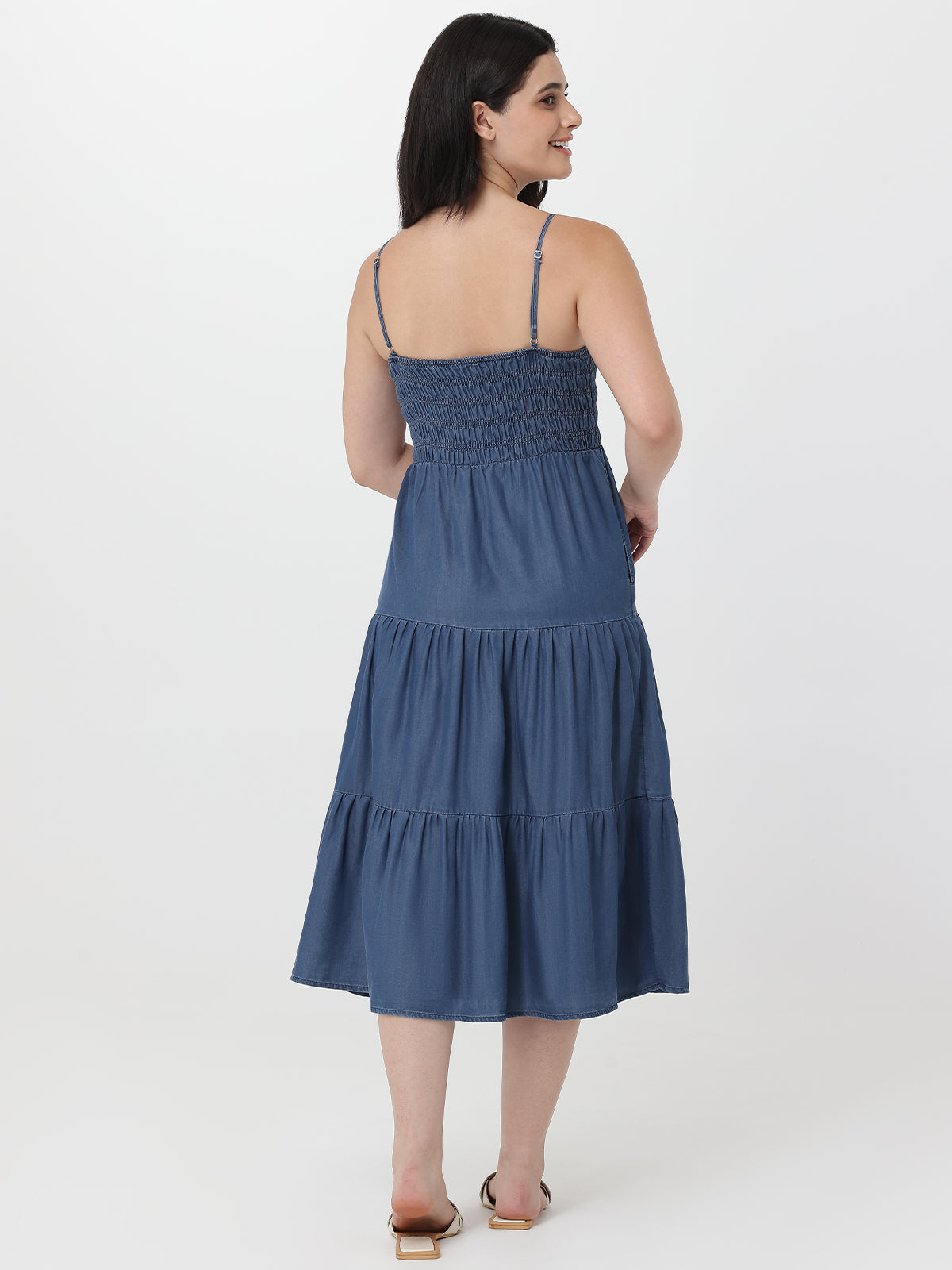 Woman wearing a blue dress on a white background