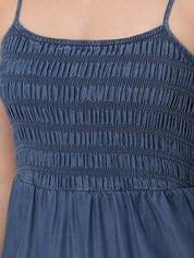 Close-up of a blue dress with smocked bodice
