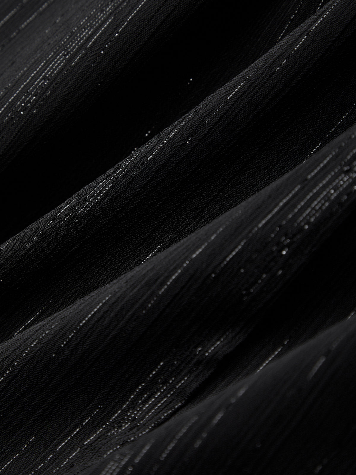 Close-up of black paint strokes on a dark background