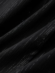 Close-up of black paint strokes on a dark background