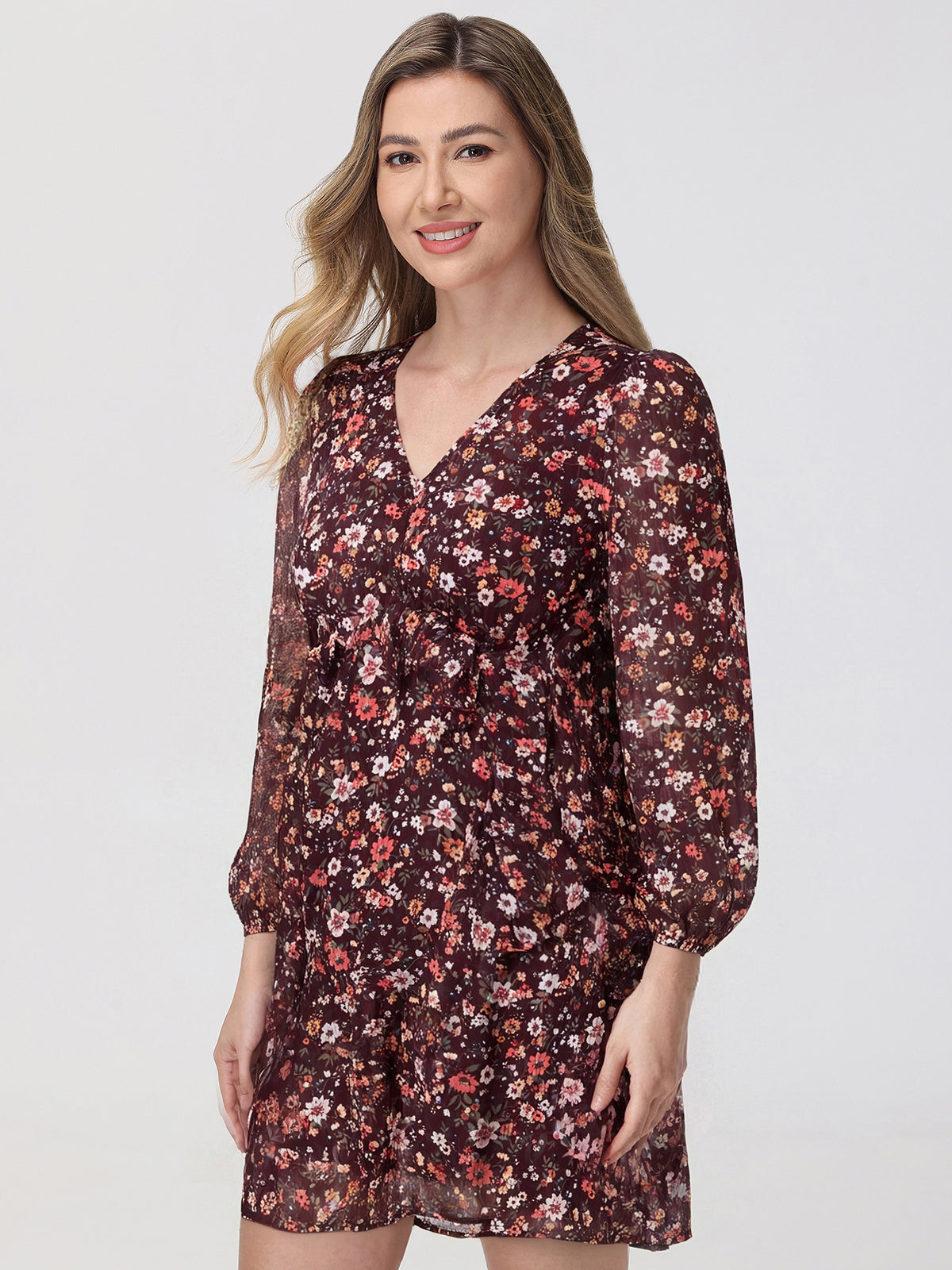 Woman wearing a floral dress on a plain background