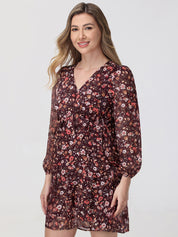 Woman wearing a floral dress on a plain background