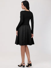 Woman wearing a black dress with a plain background