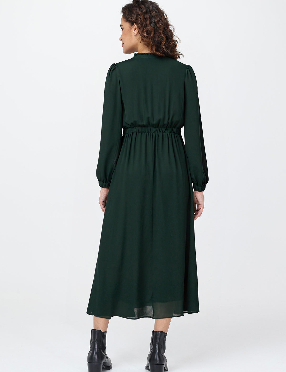 Woman wearing a green dress on a white background