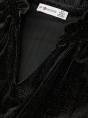 Close-up of black fabric with a brand label on a black background