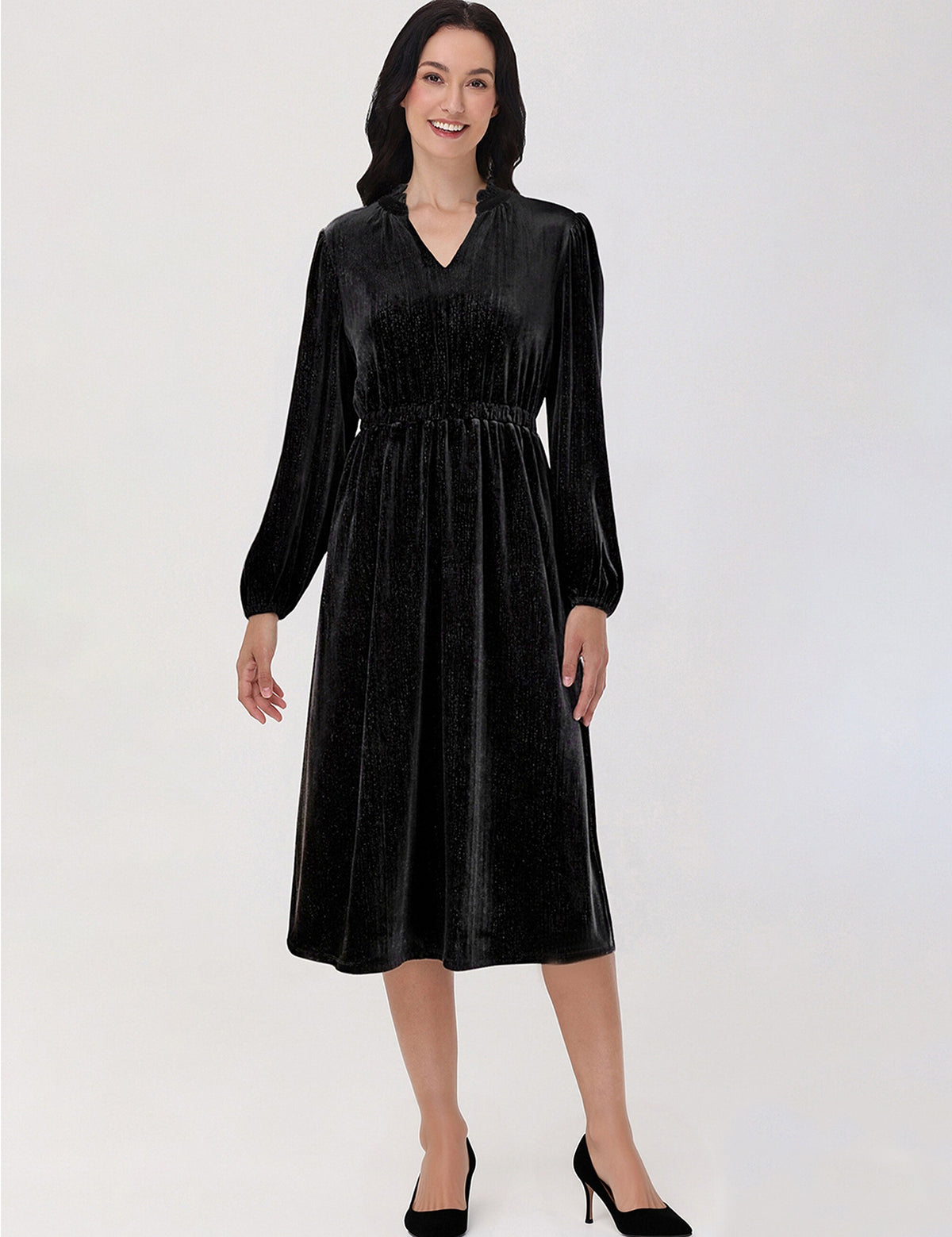 Woman wearing a black velvet dress on a white background