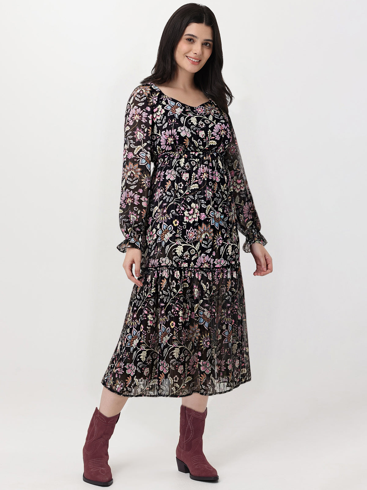 Woman wearing a floral dress with long sleeves on a white background