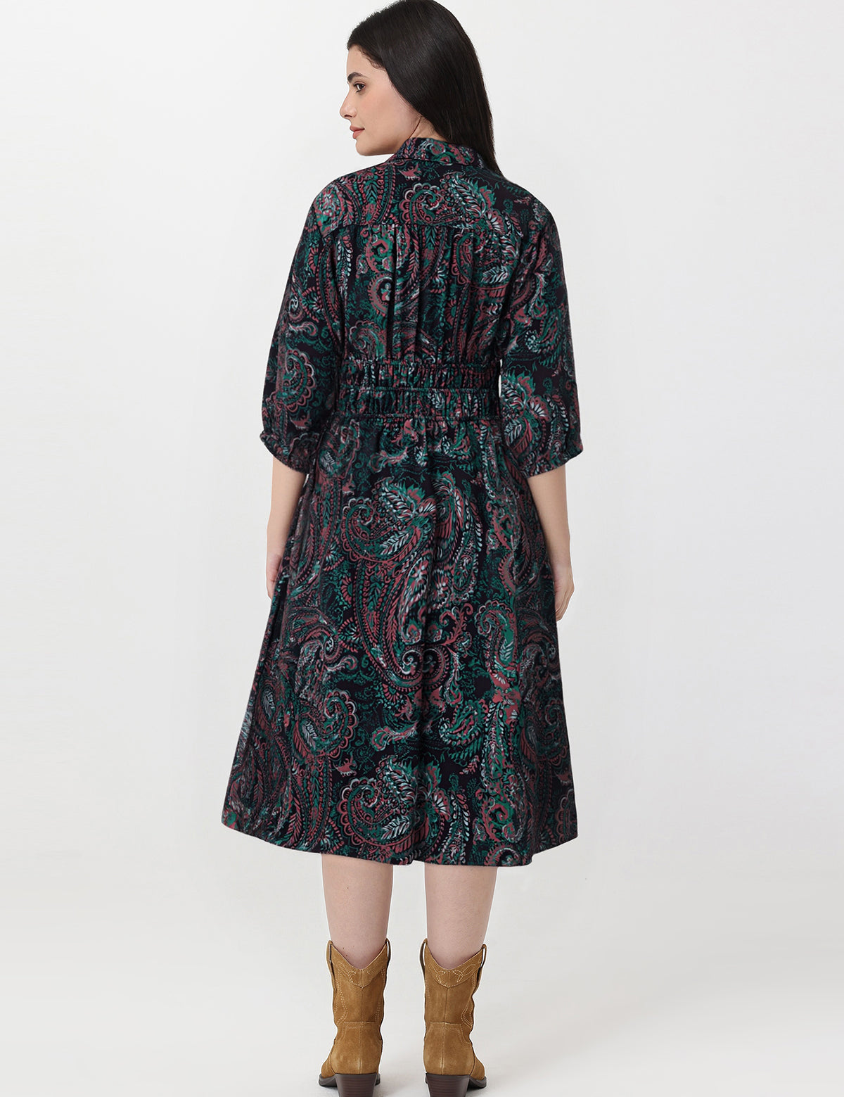 Woman wearing a patterned dress with a white background