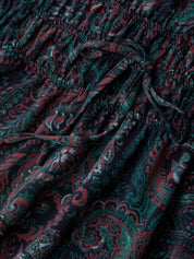 Close-up of dark fabric with red and green paisley pattern