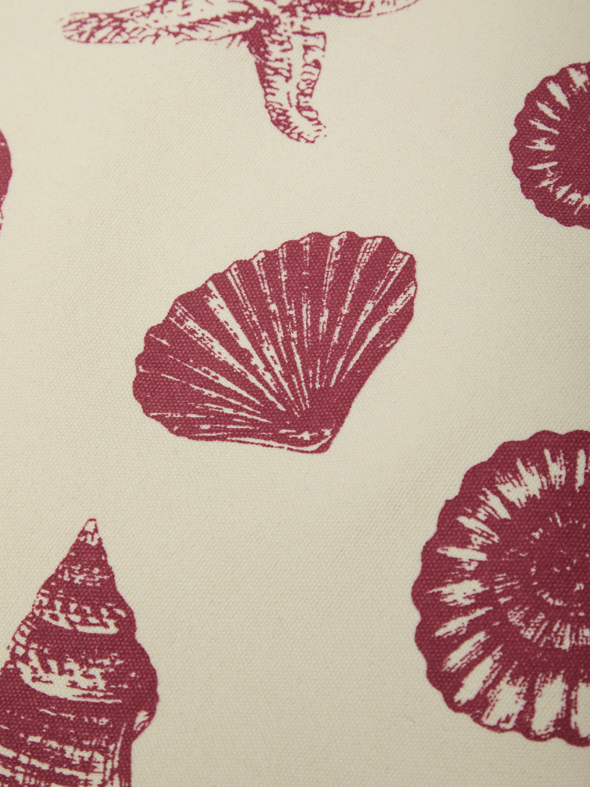 Pattern of red shell designs on a beige background