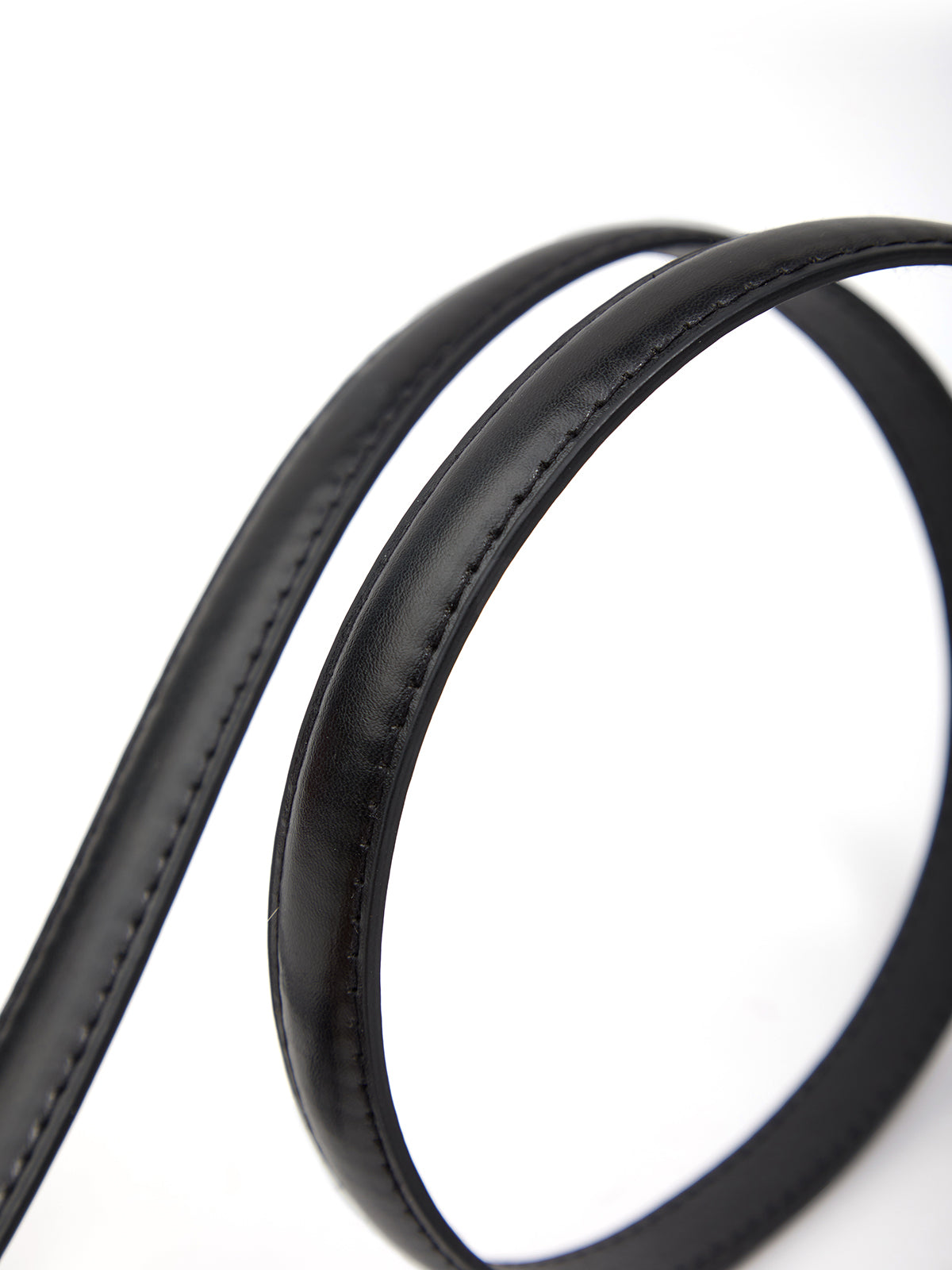 Close-up of a black leather belt on a white background