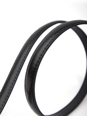 Close-up of a black leather belt on a white background