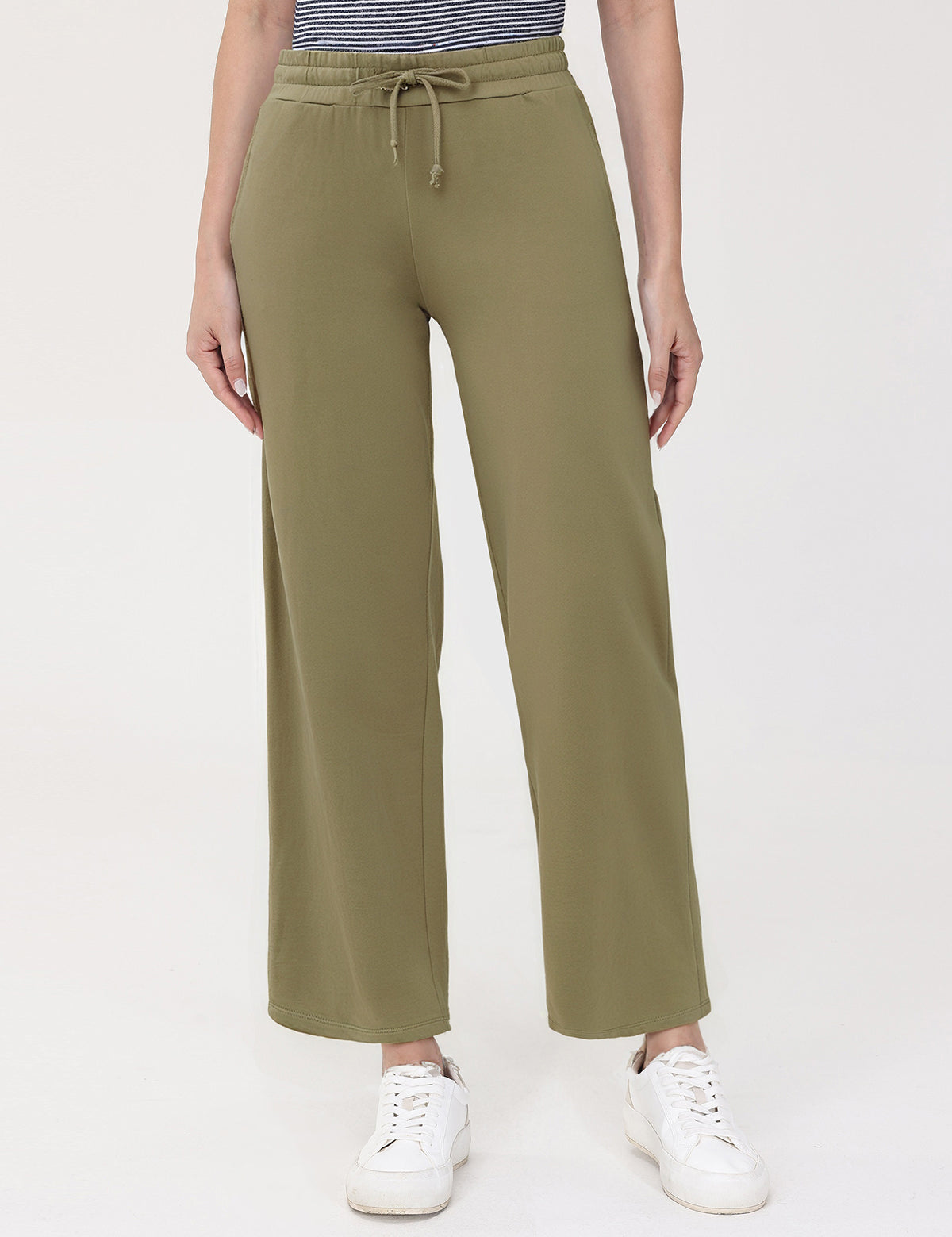 Person wearing olive green wide-leg pants on a white background