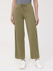 Person wearing olive green wide-leg pants on a white background