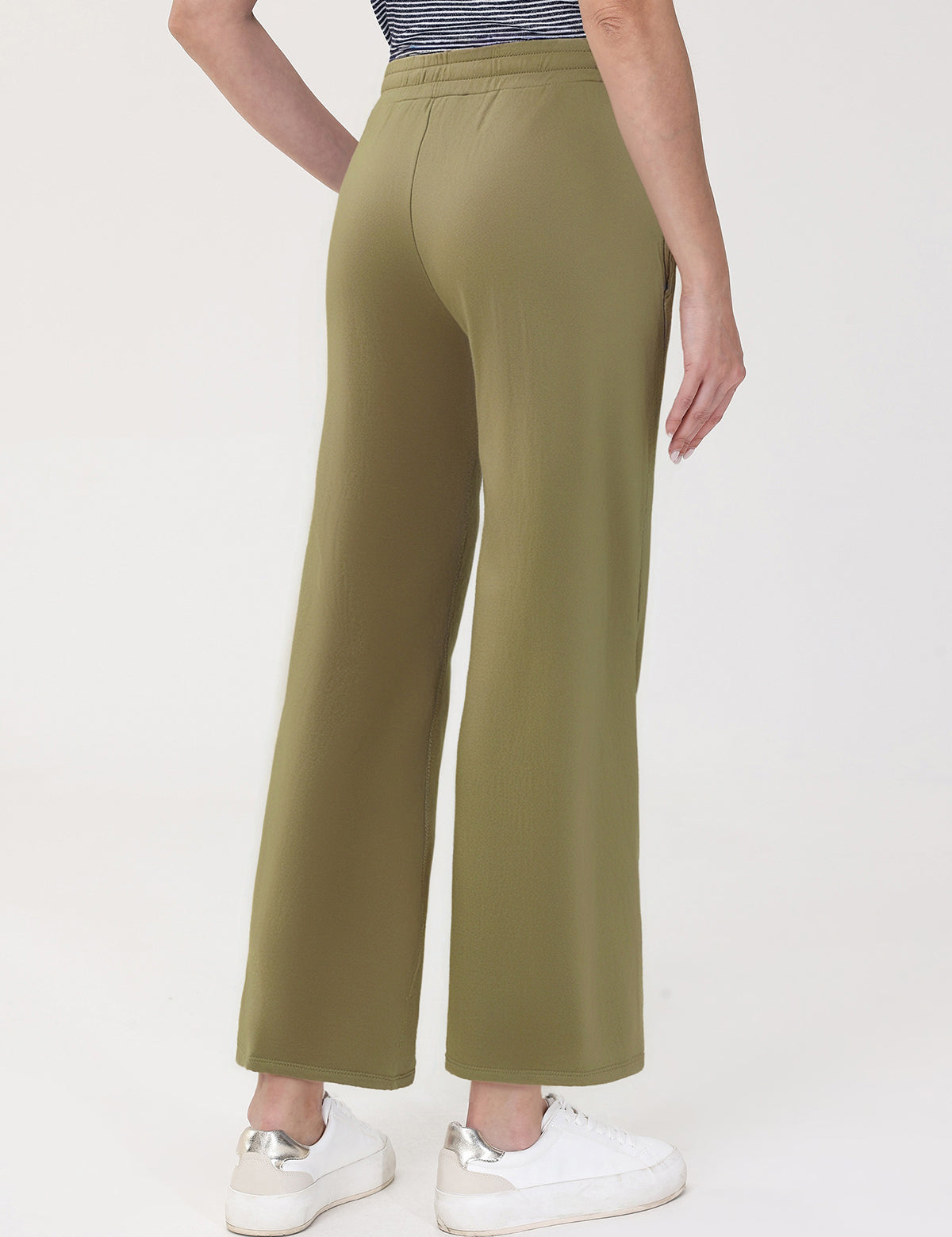 Person wearing olive green pants on a white background