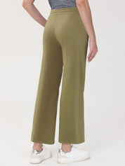 Person wearing olive green pants on a white background