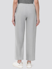 Person wearing light gray wide-leg pants on a white background