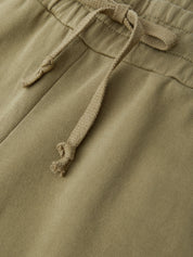 Close-up of green pants with drawstring waistband