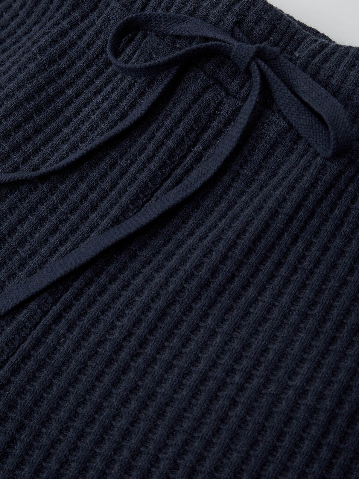 Navy waffle knit fabric with a textured pattern