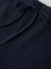 Navy waffle knit fabric with a textured pattern