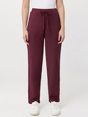 Person wearing maroon waffle pants on a white background
