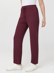 Maroon waffle pants worn by a person on a white background