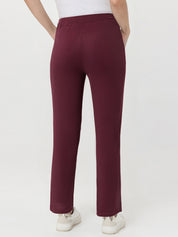 Maroon waffle pants worn by a person on a white background