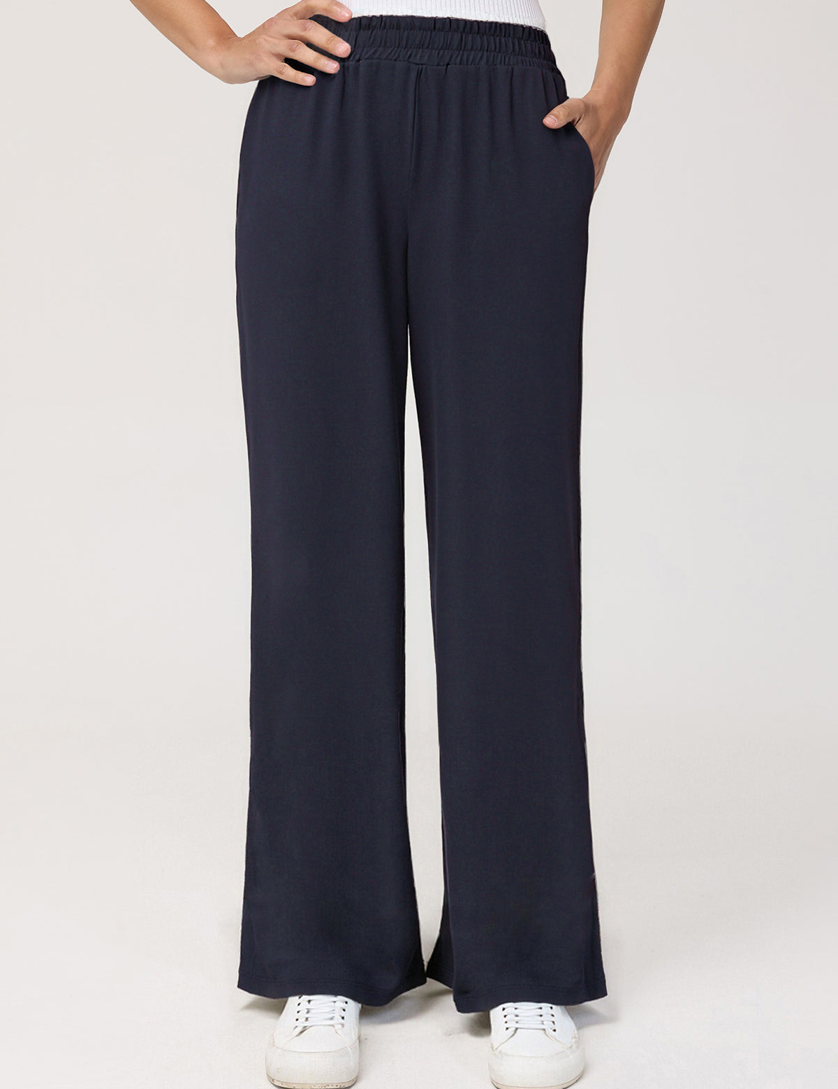 Navy wide-leg pants worn by a person on a white background