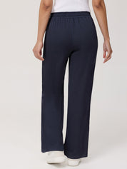 Navy blue pants worn by a person on a white background