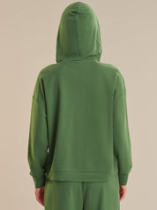 Green hoodie on a beige background