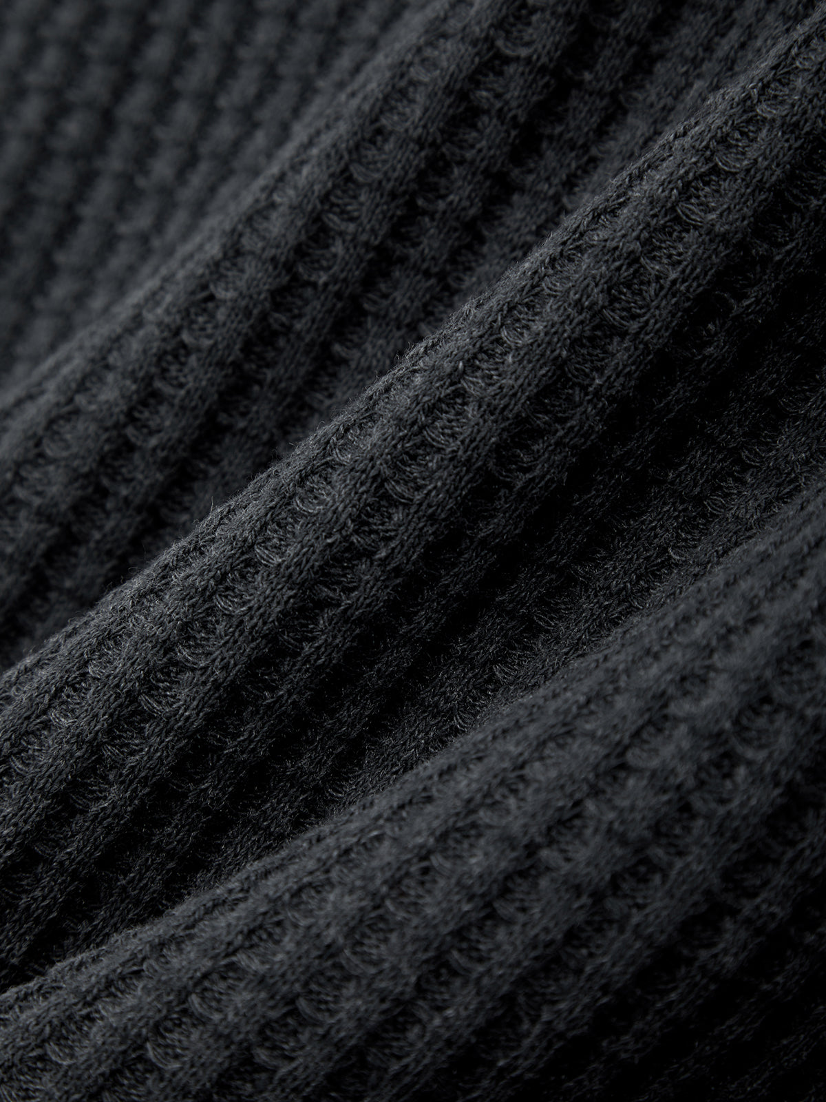 Close-up of black textured fabric with a ribbed pattern