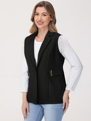 Woman wearing a black vest over a white shirt with a plain background