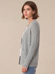 Woman wearing a gray cardigan on a beige background