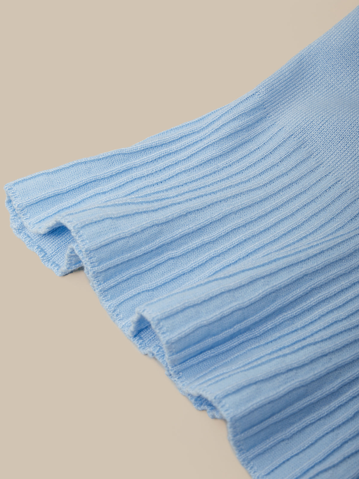 Close-up of a blue textured fabric on a beige background