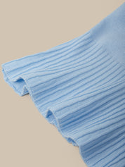 Close-up of a blue textured fabric on a beige background