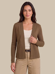 A woman modeling a ribbed open-front cardigan in taupe brown, worn over a cream tank top and beige pants, against a solid beige studio background.