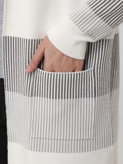 Person wearing a black and white striped shirt with a pocket detail.