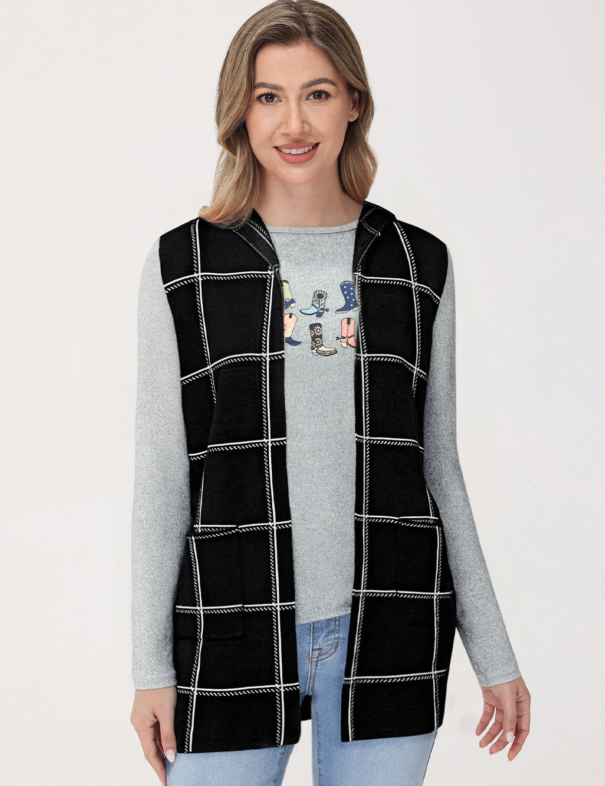 Woman wearing a black checkered vest over a gray long-sleeve shirt on a white background