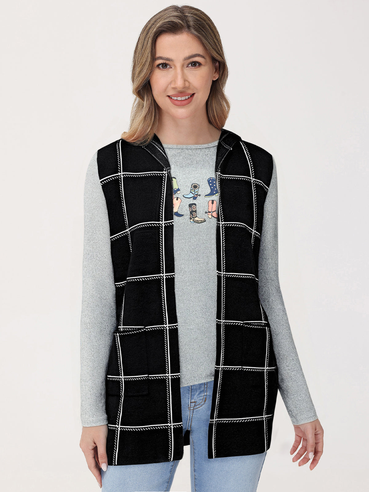 Woman wearing a black checkered vest over a gray long-sleeve shirt on a white background
