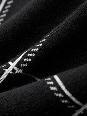 Close-up of black fabric with white stitching details
