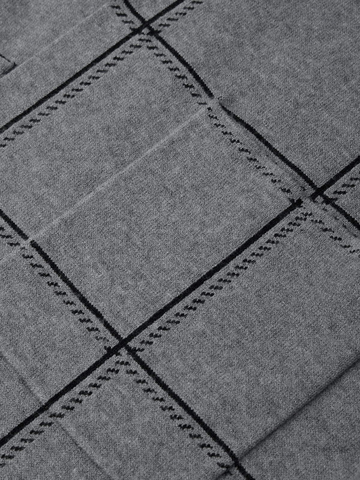 Close-up of gray fabric with black stitching pattern
