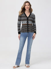 Woman wearing a patterned cardigan and blue jeans on a white background