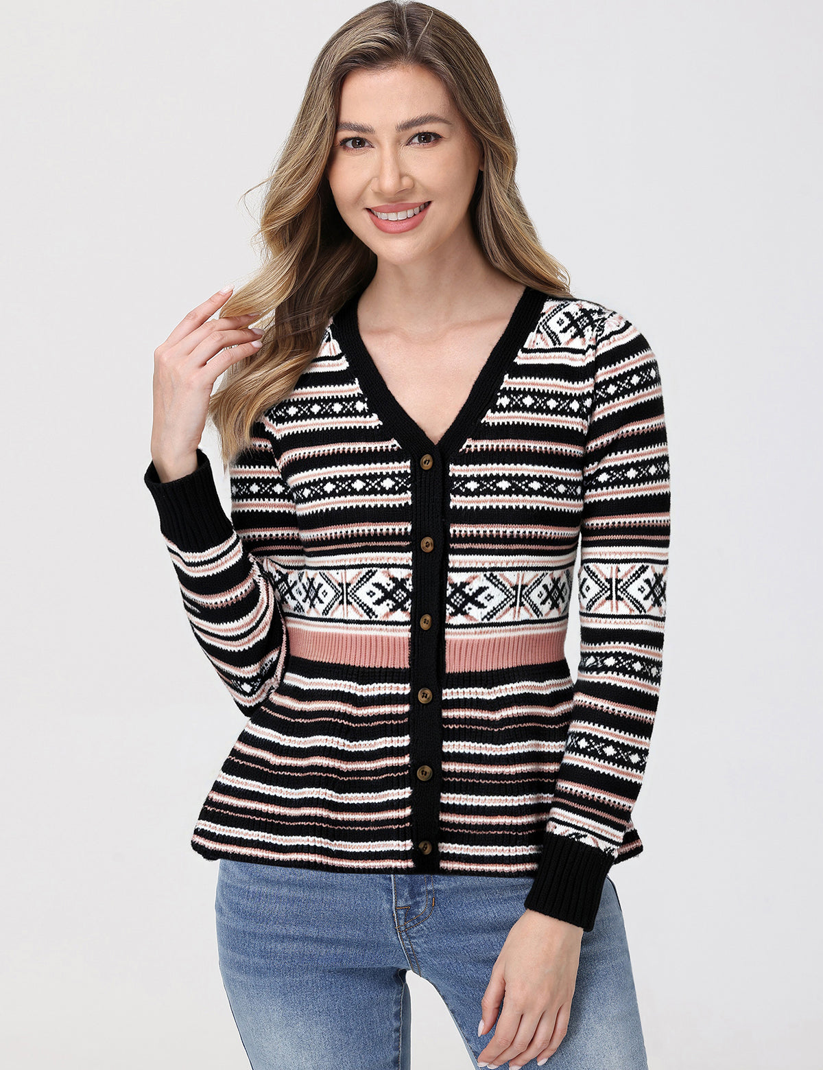 Woman wearing a patterned cardigan with a plain background