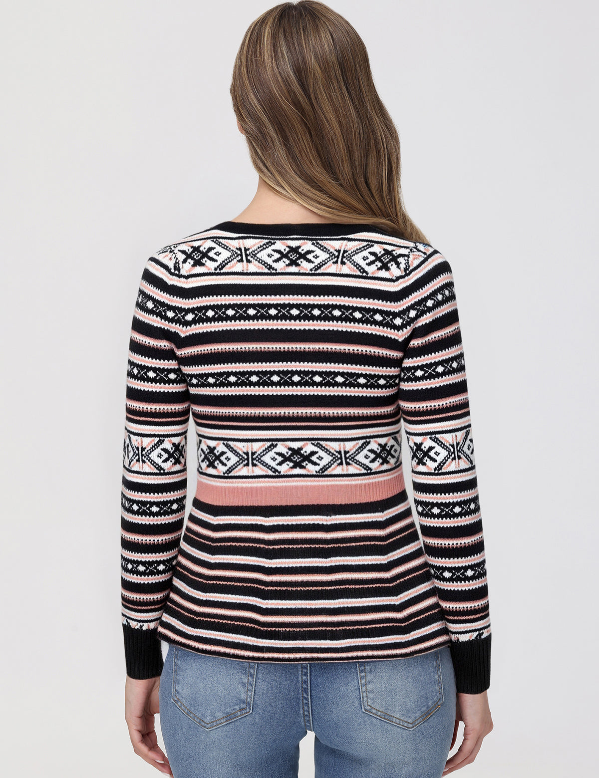 Person wearing a patterned sweater with a plain background