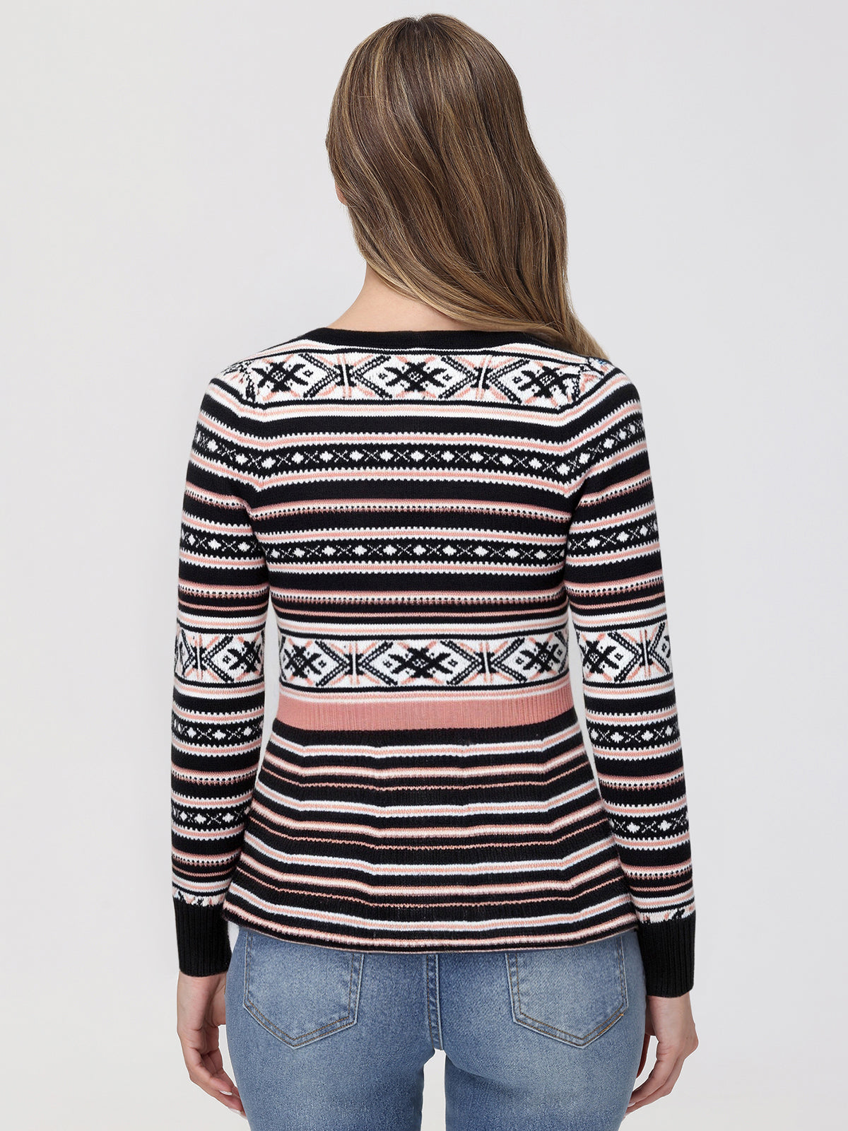 Person wearing a patterned sweater with a plain background